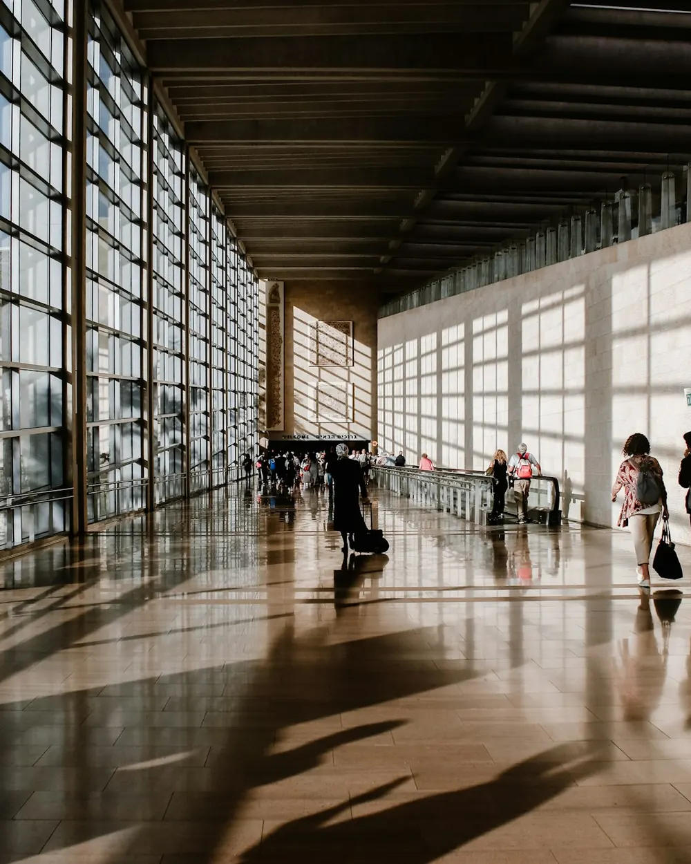 Travellers in a light-filled terminal